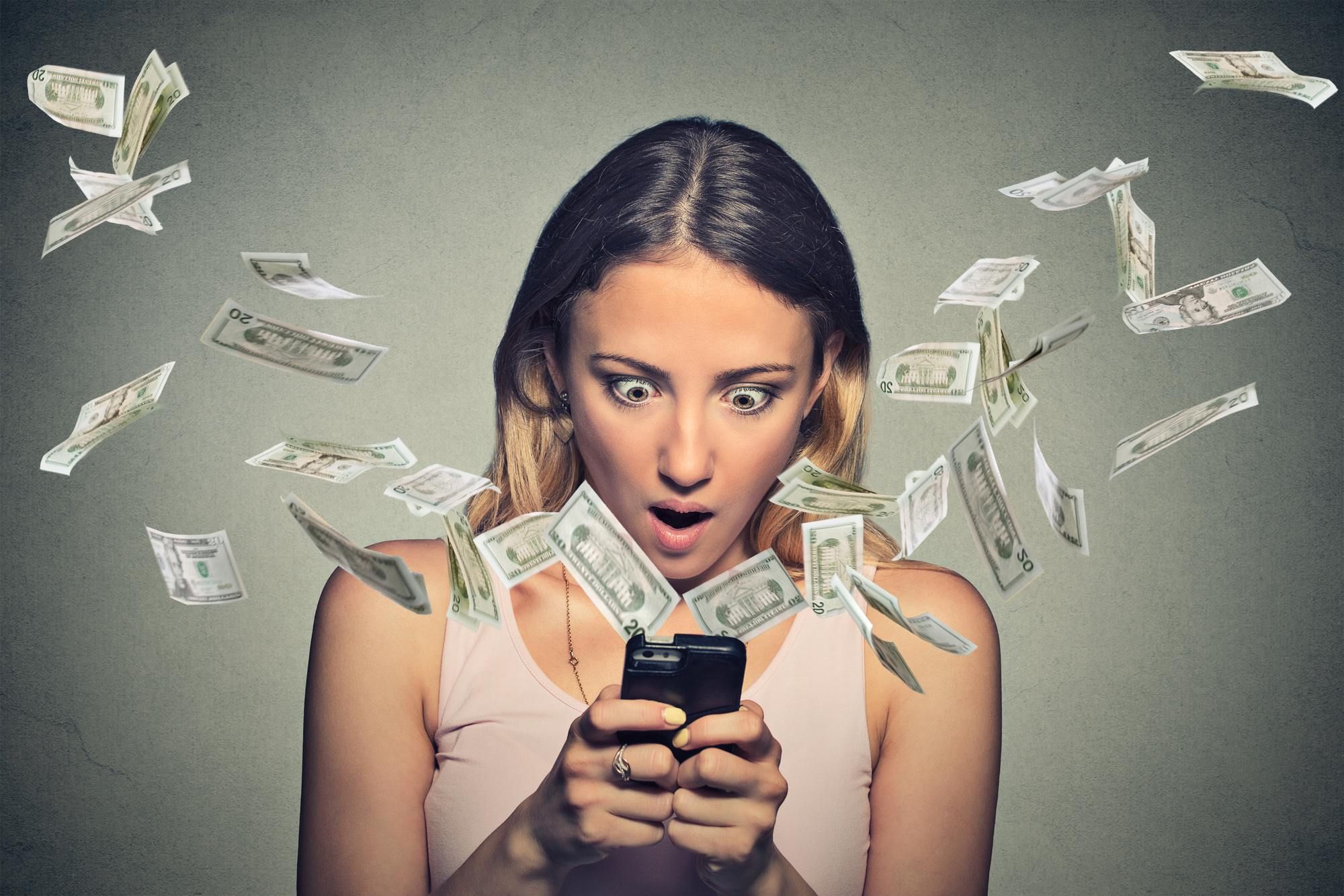 woman on smartphone watching money loss