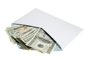 Fanned-out cash sticks out of an open envelope - ftc refunds