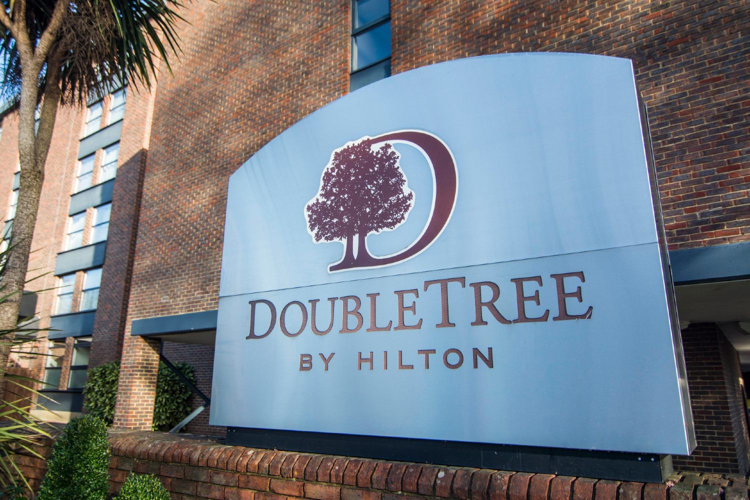 DoubleTree by Hilton sign in front of building - DoubleTree hotel franchise