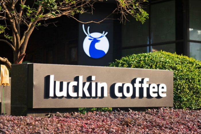 Sign for luckin coffee shop under a downtown office