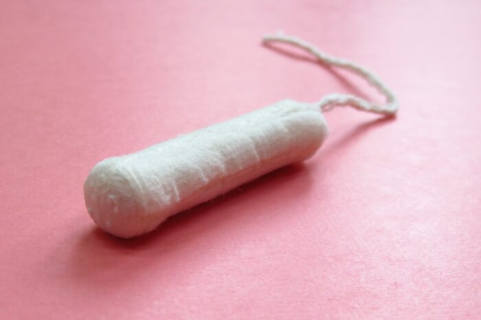 Organic Tampon without an applicator on a pink background