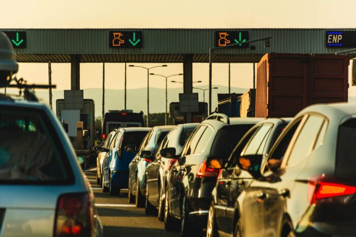 Cars wait in line on a toll road - california toll roads - BRiC