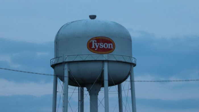 The Tyson logo is seen on a white water tower against a cloudy sky - price fixing class action