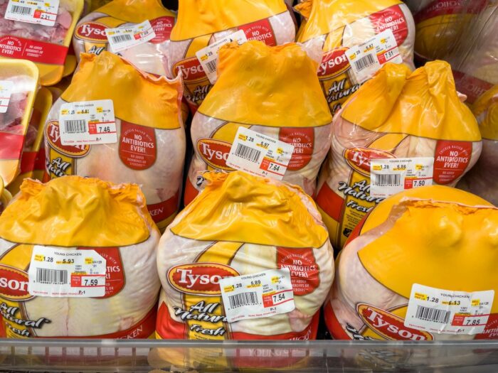 Packaged Tyson chickens in a grocery store, representing the broiler chicken price-fixing settlement. No proof of purchase is required for consumers to submit a claim under the class action lawsuit settlement.