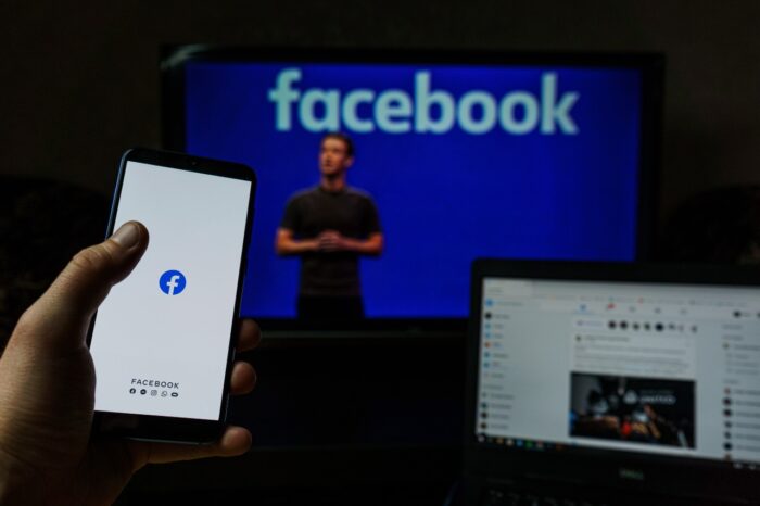 Facebook is seen on a laptop, a smartphone, and another screen - facebook moderators - facebook class action