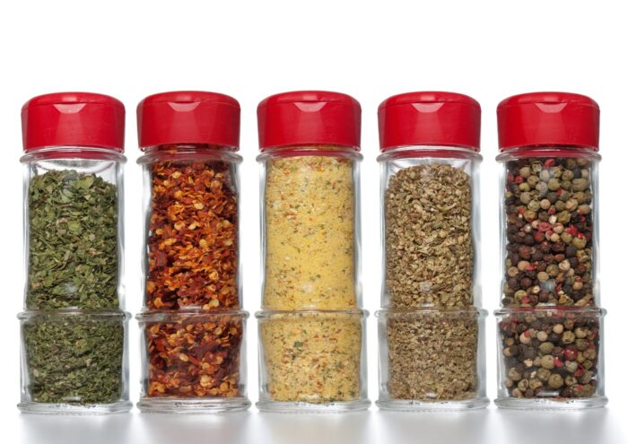 Spices in glass bottles with red lids - McCormick