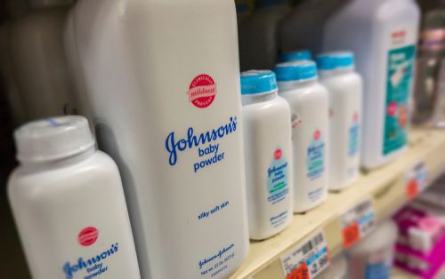 Bottles of Johnson and Johnson baby powder on a store shelf.
