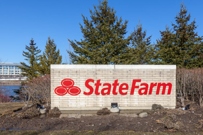 Aurora, Ontario, Canada - April 22, 2018: Sign of State Farm with Aurora Operations Centre in background near Toronto, Canada. State Farm is a large group of insurance and financial services companies; State Farm, class action, insurance