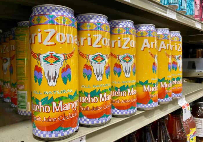 Large aluminum cans of Arizona branded iced tea, mucho mango flavor.