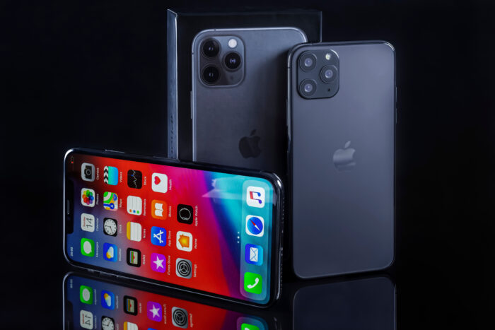 iPhone 11 Pro and iPhone XS Max. iPhone Xs Max front view and iPhone 11 Pro back view on black background. Apple, radiation, FCC, class action
