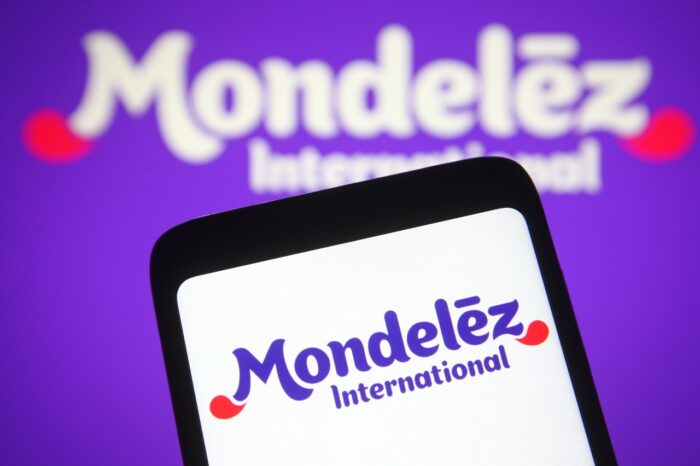 Mondelēz logo on smartphone screen and in the background - belVita biscuits, belVita Settlement 