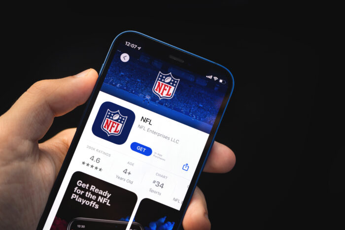 NFL app, man hold mobile phone with application on the screen, data privacy