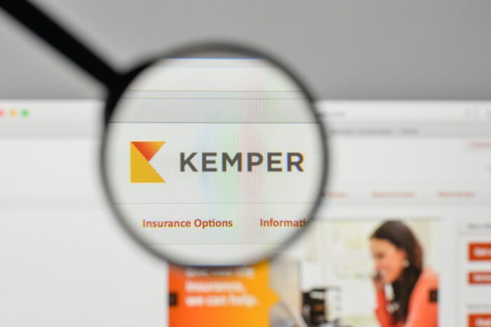 Kemper corp. logo is seen on a computer screen under a magnifying glass - Infinity Insurance Co. - kemper data breach