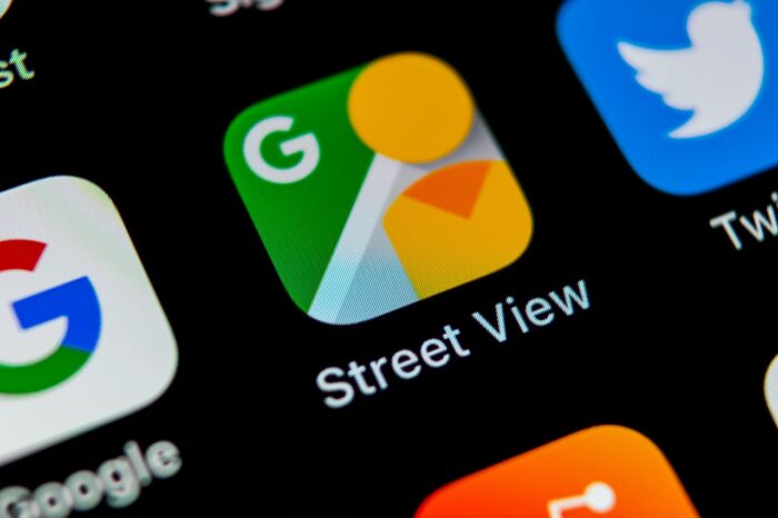 Google Street View application icon on Apple iPhone X screen close-up. Google StreetView app icon.