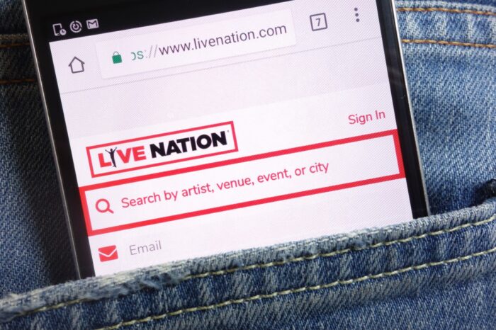 Live Nation website displayed on smartphone hidden in jeans pocket