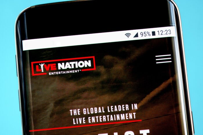 The Live Nation Entertainment website homepage is seen on a smartphone, representing the Live Nation and Ticketmaster class action lawsuit.