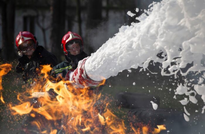 Firefighters extinguish a fire with foam - 3m, class action, forever chemicals