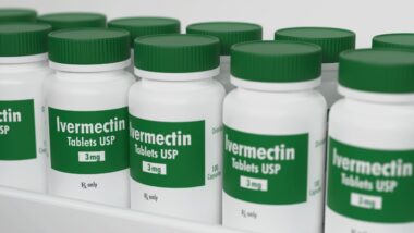 Ivermectin tablets in bottle on pharmacy shelf 3d rendering