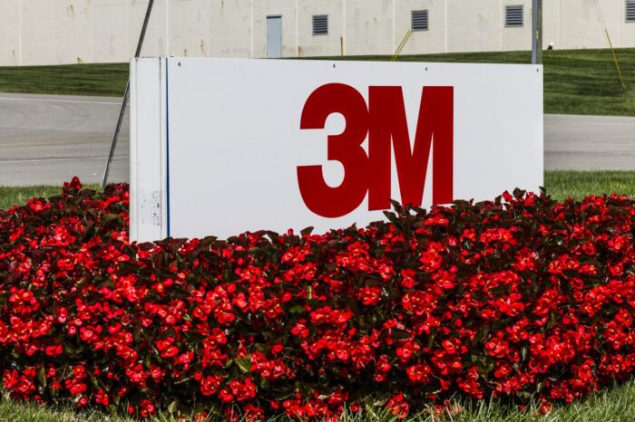 3M sign surrounded by red flowers - tennessee river contamination - pfas settlement - 3m class action