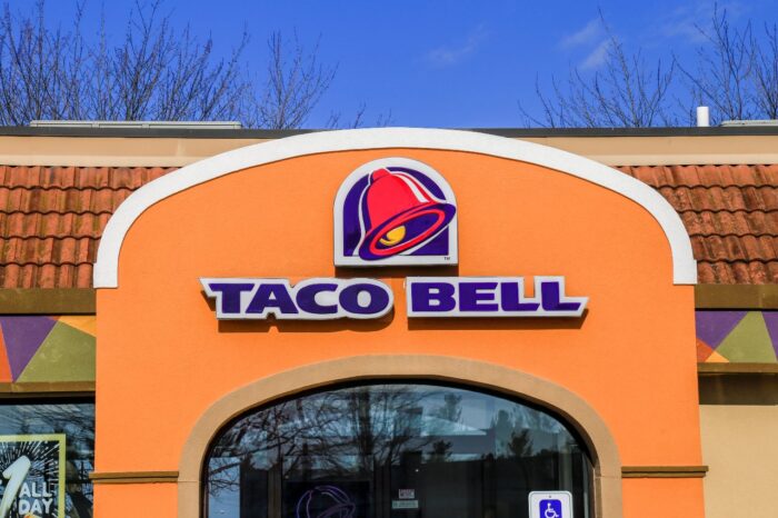 Exterior of Taco Bell fast-food restaurant with sign and logo.