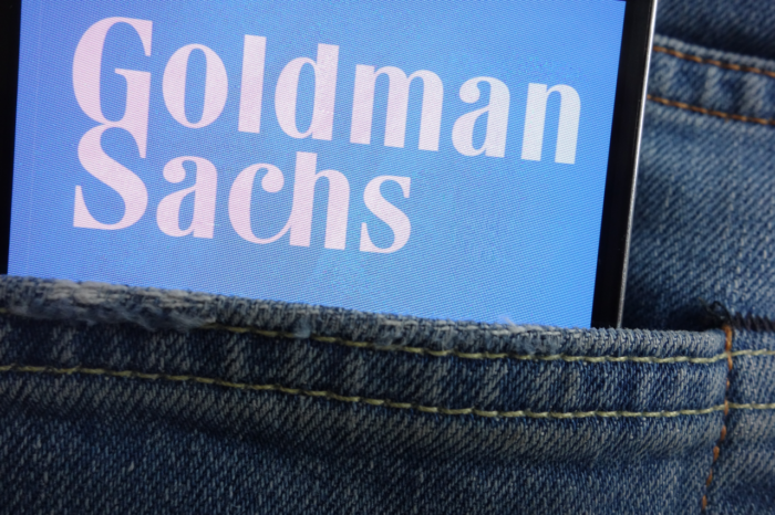 Goldman Sachs logo displayed on smartphone hidden in jeans pocket
