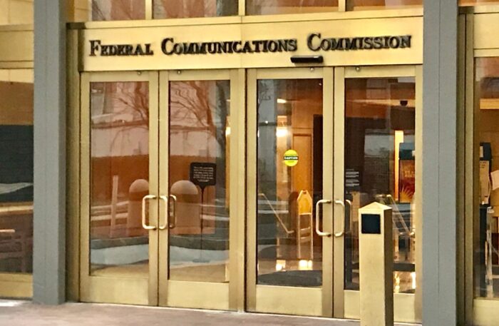 FCC - FEDERAL COMMUNICATIONS COMMISSION headquarters building entrance with sign.