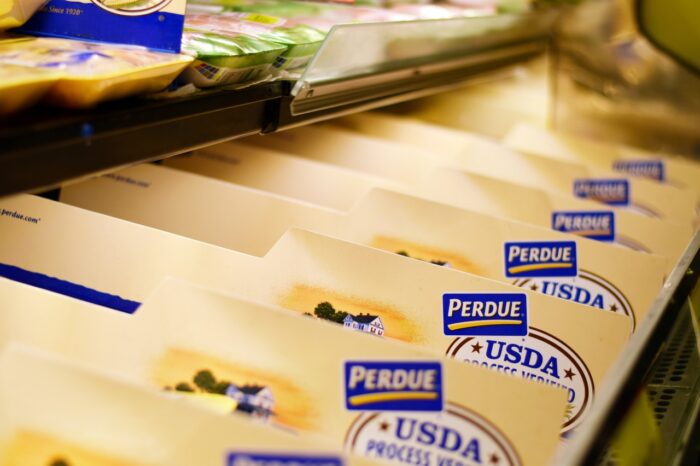Plastic wrapped Perdue chicken products in a grocery store