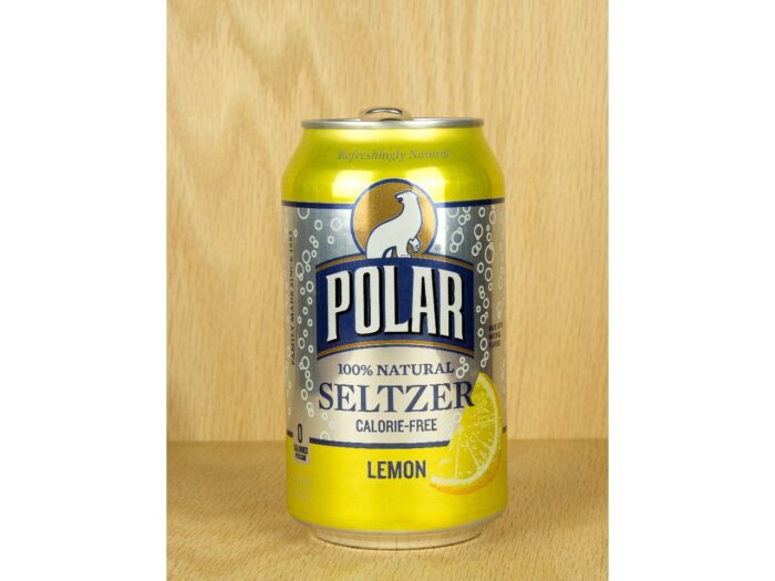 A can of Polar brand lemon seltzer water with a wood background.