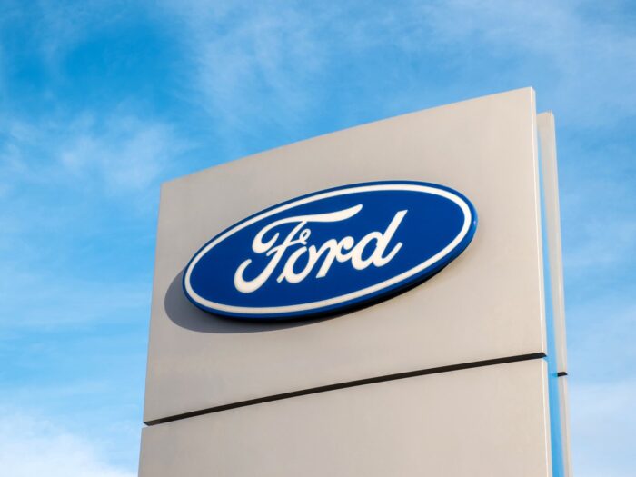 Ford dealership sign against a blue sky.