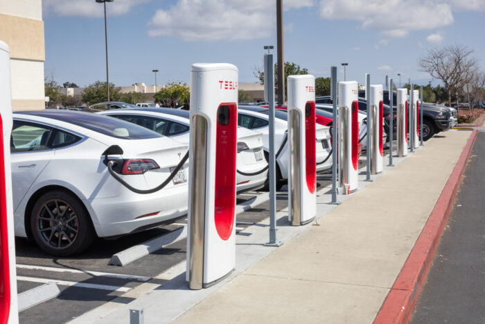 A row of Tesla vehicles parked at a supercharger station in California