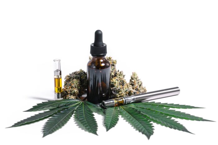 Marijuana White Display of Hemp Oil Buds Leaves and Vape Pen - select product - select cannabis settlement - cura partners