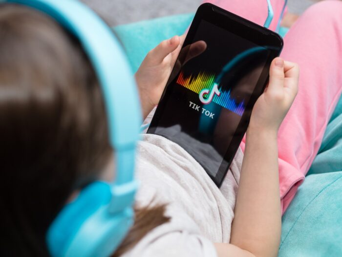 tablet in kids hands with Tik Tok icon