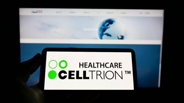 Person holding mobile phone with logo of biopharmaceutical company Celltrion I