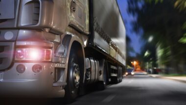 truck drives on a night road; concept Commercial Trucking Accident