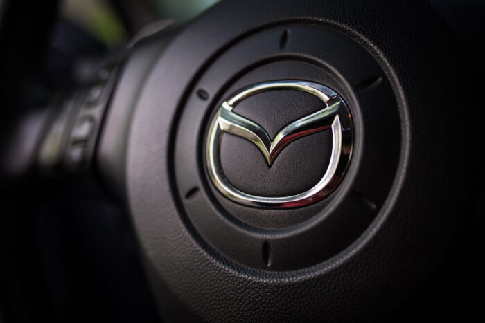 Mazda car logo on the steering wheel.