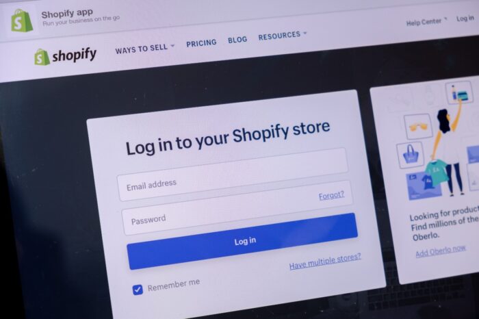 Shopify Website in laptop screen with black background.