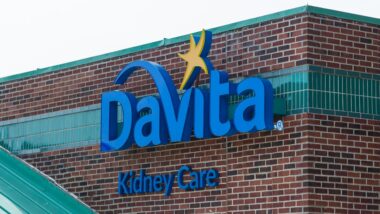 Davita Kidney Care sign, on the side of their brick building.