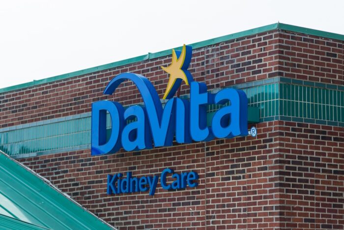 Davita Kidney Care sign, on the side of their brick building.