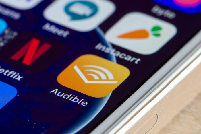 Audible mobile app icon is seen on a smartphone.