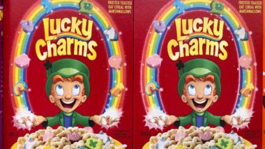Boxes of General Mills Lucky Charms cereal on super market shelf.