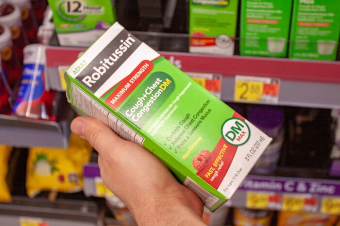 Robitussin cough and chest congestion syrup in the pharmacy and over-the-counter aisle in a Walmart store