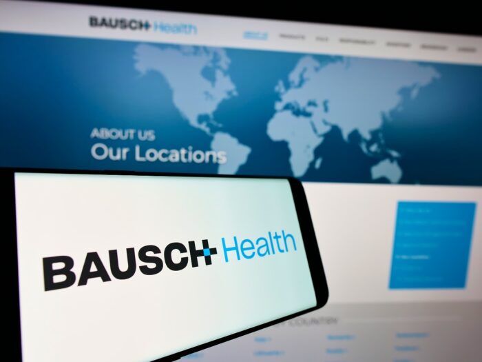 Mobile phone with logo of pharmaceutical company Bausch Health Companies Inc on screen in front of website - glumetza antitrust