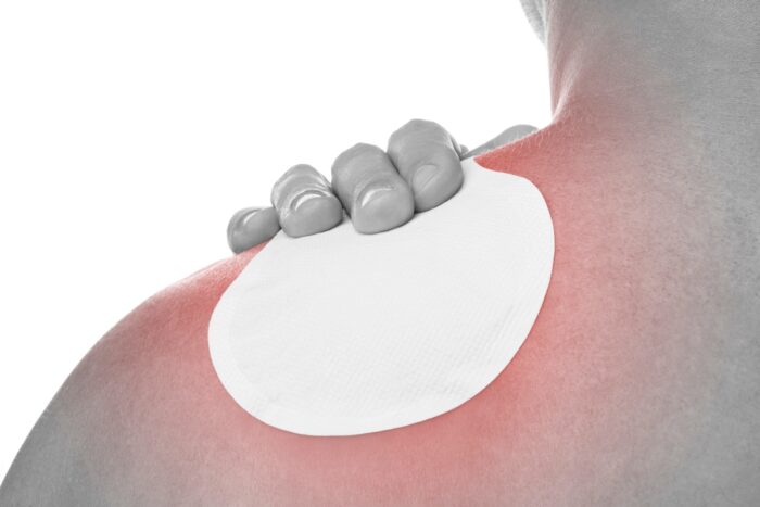 Medical patch therapy for pain relief with an occupational disease syndrome of a young man with shoulder pain.