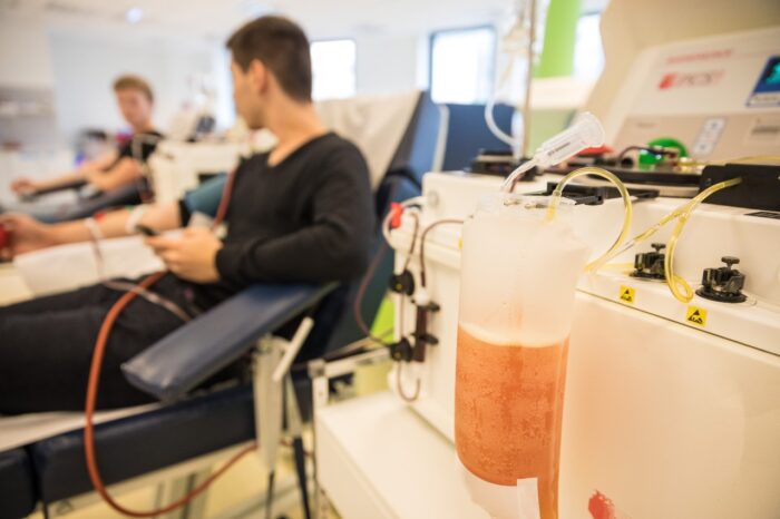 Two people donate blood plasma - BioLife Settlement - biolife class action