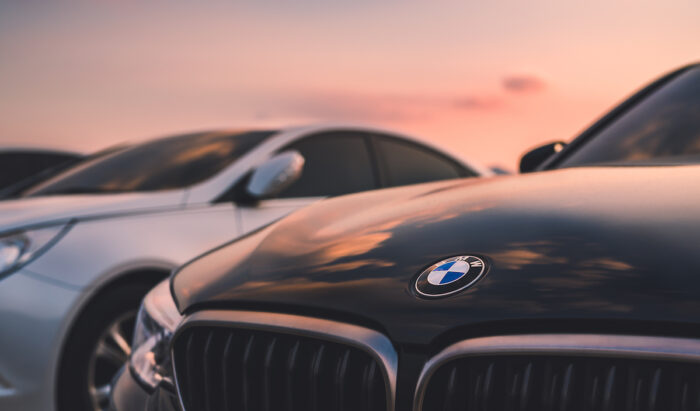 BMW car underneath a sunset sky.