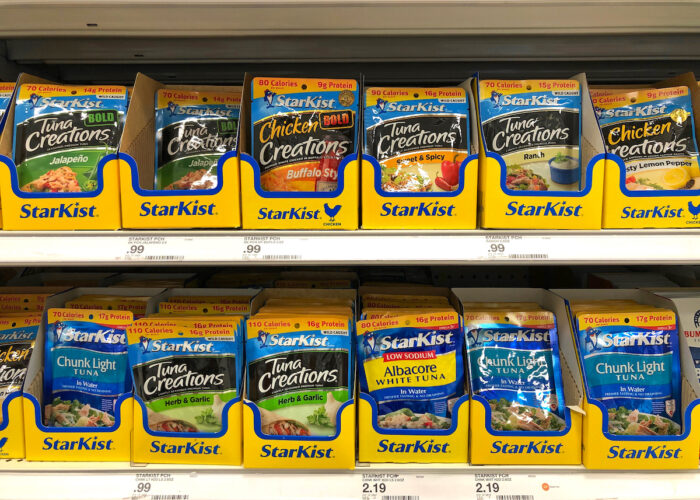 Grocery store shelf with foil pouches of StarKist brand tuna in various flavors - kroger, price-fixing, canned tuna