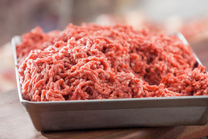 Closeup of tray filled with minced meat in butchery.