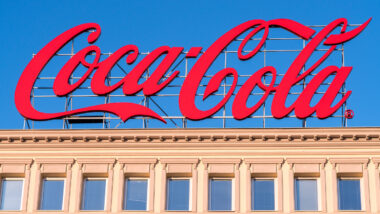 Large Coca-Cola advertising sign on rooftop.