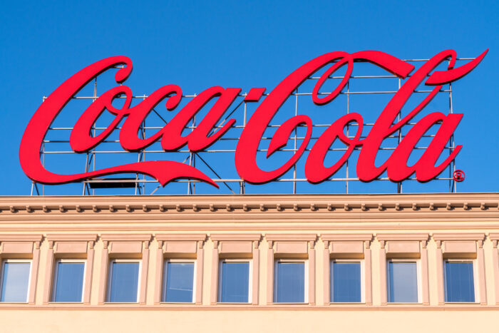 Large Coca-Cola advertising sign on rooftop, representing the Coca-Cola Kronos hack class action settlement.