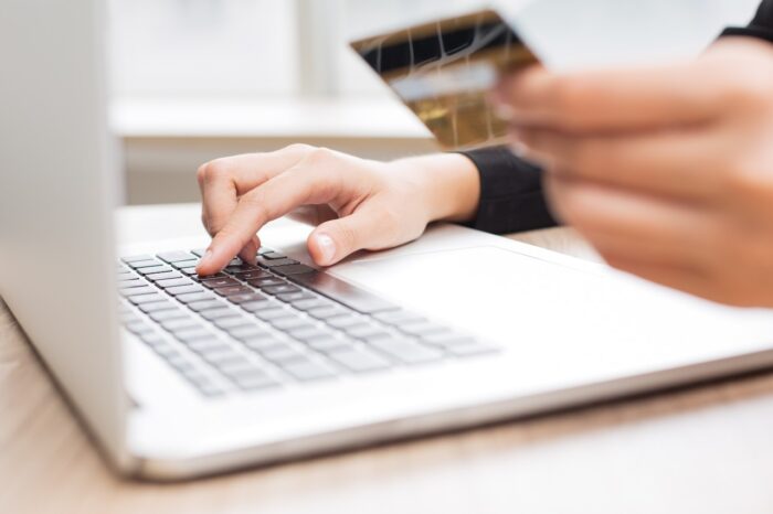 Cropped View of Person Making Online Purchase - on point global lawsuit, on point claim form